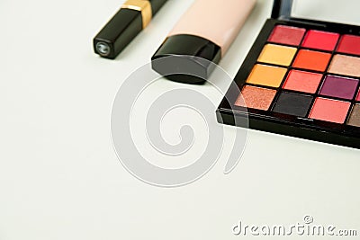 Makeup in pink shades. various cosmetics. shadows, Foundation and mascara isolated on a light grey background. Stock Photo