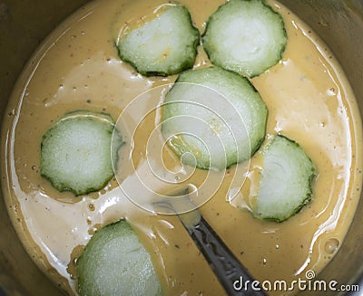 making aloo bhajiya with snake gourd and ridge gourdturi ,spoon Stock Photo