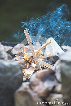 Making a bonfire: Small flame on a camping trip, adventure outdoors Stock Photo