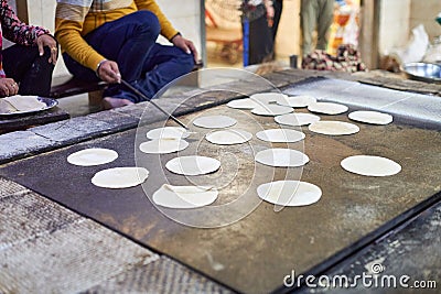 Making of chapati round flatbreads for langar in sikh gurudwara temple many uncooked roti flatbreads Stock Photo