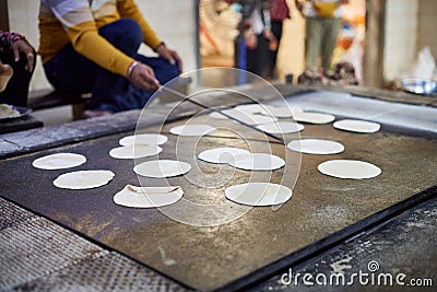 Making of chapati round flatbreads for langar in sikh gurudwara temple many uncooked roti flatbreads Stock Photo