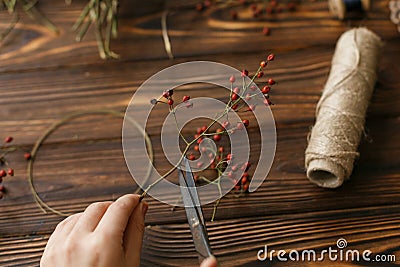 Making christmas wreath on rustic wooden table, holiday advent Stock Photo