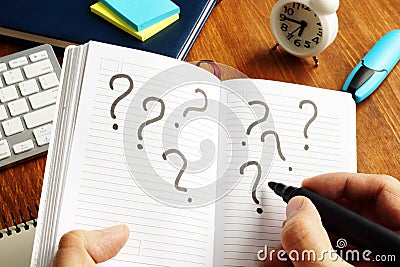 Making decision and uncertain. Question marks in note Stock Photo