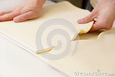 Making dough by male hands at bakery Stock Photo