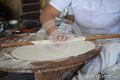 Making dough for pizza at home. kneading, rolling, female hands in the frame. Preparation of dough, kneading Stock Photo