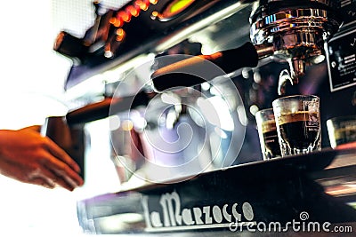 Making espresso coffee close up detail with modern machine Editorial Stock Photo