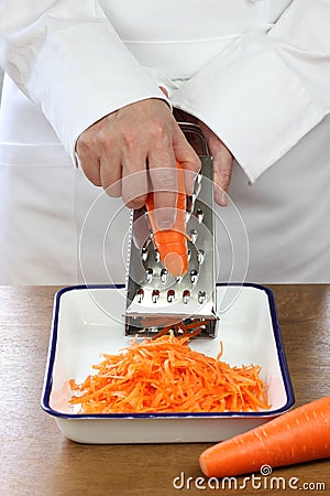 Making grated carrot salad, shredding carrots Stock Photo