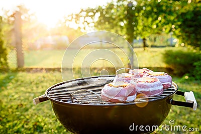 Making home made Beer Can Bacon Burgers on barbecue grill. Stock Photo