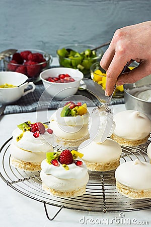 Making Mini Tropical Fruit Pavlovas Stock Photo