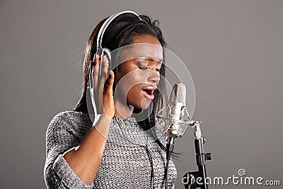 Making music beautiful black woman singing in mic Stock Photo