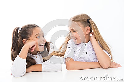 Making new friends in school. Happy small friends talking during class. Little school friends smiling to each other Stock Photo