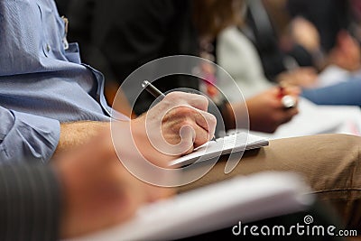 Making notes at conference, detail. Stock Photo