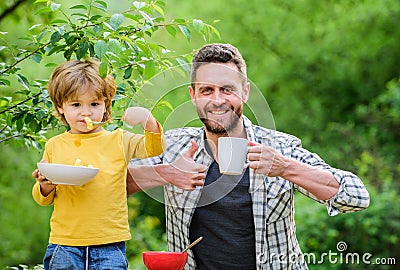 Making nutritional choice. healthy food and dieting. Dairy products. Morning breakfast. son and father eating. happy Stock Photo