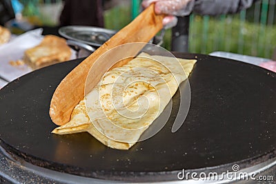 Making pancake with filling on frying electric stove Stock Photo