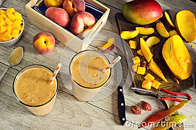 Making Peach Mango Smoothies with Sliced Fruit Stock Photo