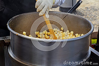 Making popcorn in the small kiosk. Heat, butter and salt Stock Photo