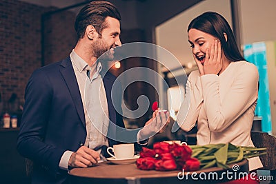 Making proposal in a cafe with ring and flowers unexpected moment honeymoon jewelry ring diamond golden concept wife husband Stock Photo