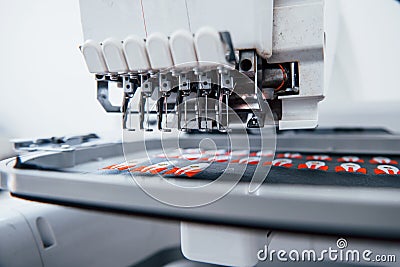 Making rocket pictures. Close up view of white automatic sewing machine at factory in action Stock Photo