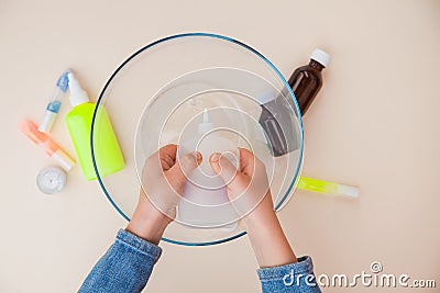 Making slime, step by step instruction, step one, adding stationery glue. Stock Photo