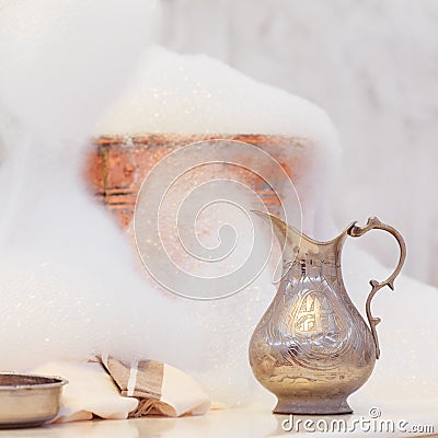 Making soap foam for massage. Water jar, towel and copper bowl w Stock Photo