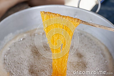 Making Thai dessert Golden Egg yolk threads Foi Thong in a pot Stock Photo