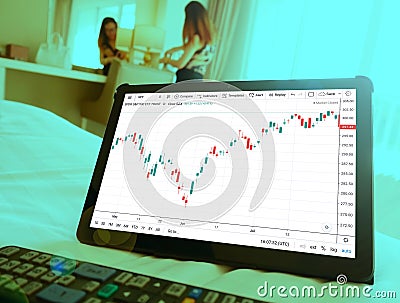 Making trading online on the smart phone. Check trend graph Editorial Stock Photo