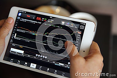 Making trading online on the tablet with old hand Stock Photo