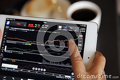 Making trading online on the tablet with old hand Stock Photo