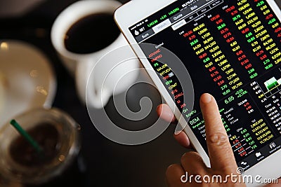 Making trading online on the tablet with old hand Stock Photo