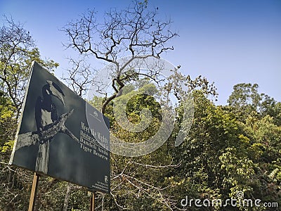 A Malaber pied horn bill, bird, Anthracoceros coronatus, also known as lesser pied hornbill, on the sign board at Dandeli Anshi Editorial Stock Photo