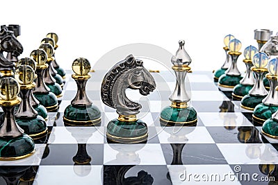 Malachite stone chess pieces on and marble chessboard Stock Photo