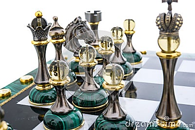 Malachite stone chess pieces on and marble chessboard Stock Photo