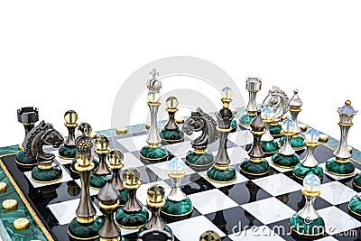 Malachite stone chess pieces on and marble chessboard Stock Photo