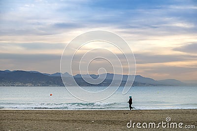 woman strolling on the sand Editorial Stock Photo