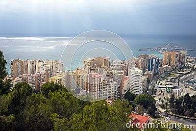 Buildings, port, bay, ships against a cloudy sky. Dramatic Editorial Stock Photo