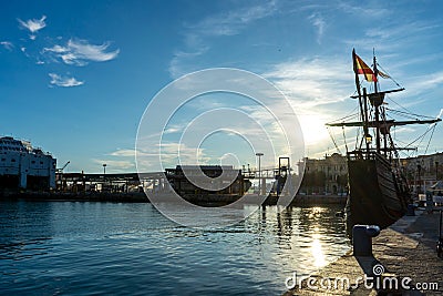Black sailing yacht on sunset in port in Malaga, Spain on January 14, 2023 Editorial Stock Photo