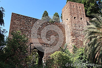 Tower and defensive walls of the Alcazaba of Malaga. Palatial fortification from the Islamic era built in the 11th century Editorial Stock Photo