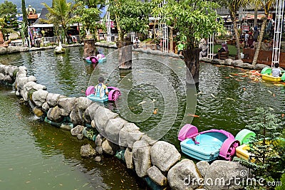 Children driving children's water boats on the water. Editorial Stock Photo