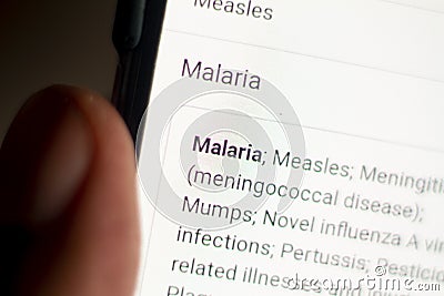 Malaria News on the phone.Mobile phone in hands. selective focus and chromatic aberration effects Stock Photo
