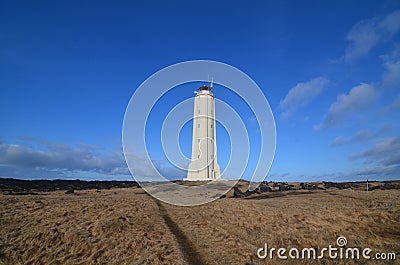 Malarrif Lighthouse with Hay Fields with Black Lava Rocks Stock Photo