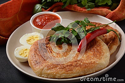 Malawach with hard boiled eggs and tomatoes. Malawach or malawah: traditional fried bread of Yemenite Jews Stock Photo