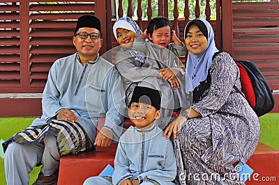 A malay family posing for the camera Stock Photo