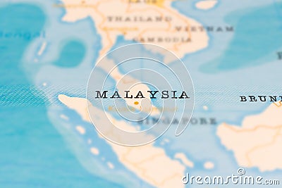 Malaysia in Focus on a Tilted World Map. Stock Photo