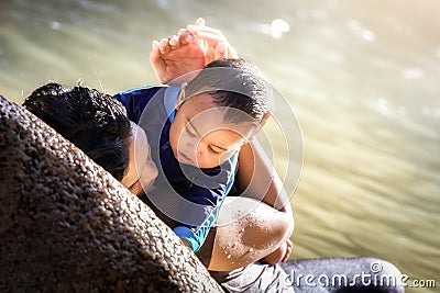 Malaysian mother holds her baby close to her chest Editorial Stock Photo