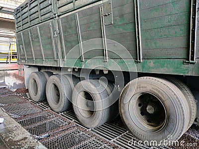 Eight tires on the side of a trailer truck carrying kernal seeds. Editorial Stock Photo