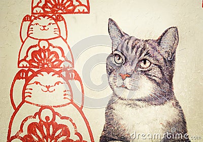MALAYSIA, PENANG, GEORGETOWN - CIRCA JUL 2014: Mural with realistic picture of a tortoiseshell cat beside red, stylized rendering Editorial Stock Photo