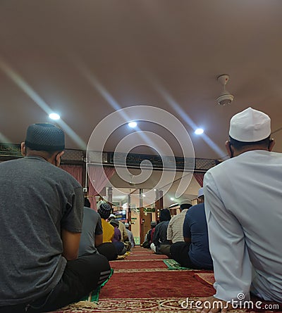 People listening to the Friday sermon at a mosque. Editorial Stock Photo