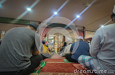 People listening to the Friday sermon at a mosque. Editorial Stock Photo