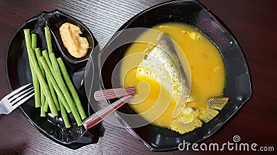 Malaysia Traditional Dish, Patin tempoyak stews served with long beans kacang panjang served with tempoyak Stock Photo