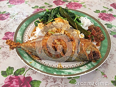 Malaysian mixed rice or `Nasi Campur` served on a plastic plate Stock Photo